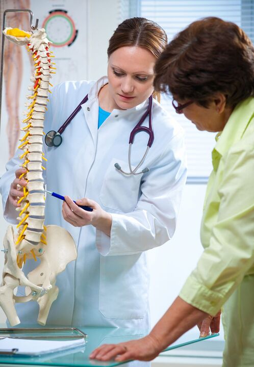 Doctor demonstrating osteonecrosis of the spine on a model
